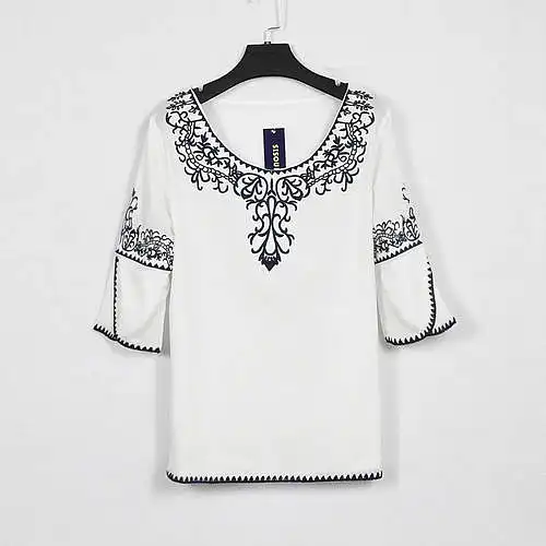 blouse ọcha nwere nkọwa ojii na akpụkpọ ụkwụ na ogwe aka